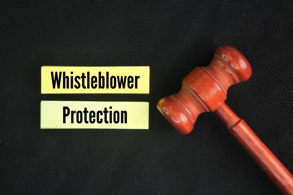 Judge’s gavel next to paper labeled ‘Whistleblower Protection.'