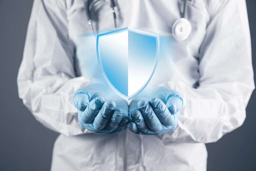 Doctor holding a glowing digital shield.