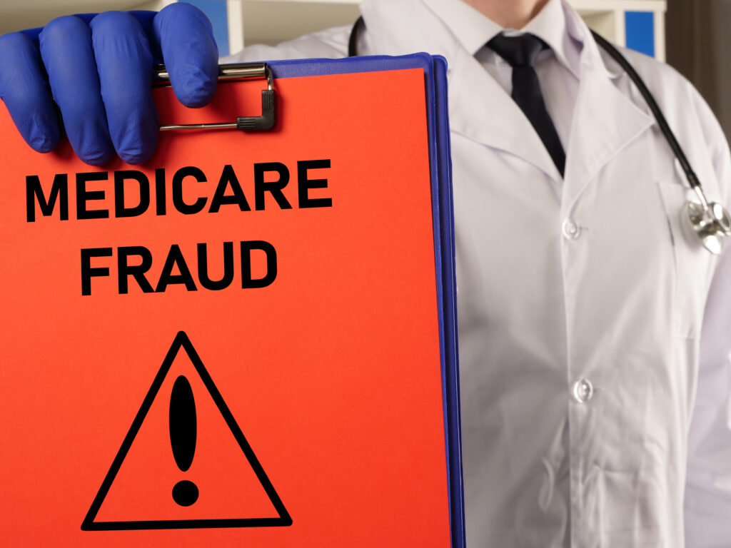 Doctor holding a binder labeled "Medicare Fraud."